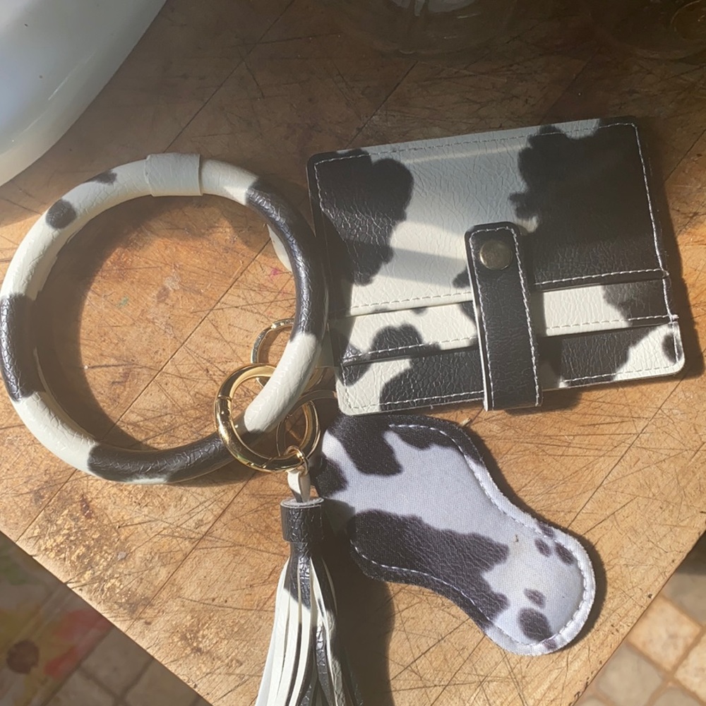 Cow print wristlet with gold accents